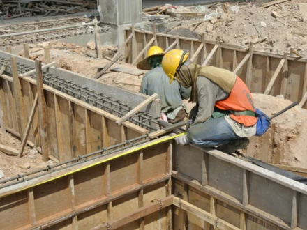 depositphotos_73965839-stock-photo-two-construction-workers-installing-ground