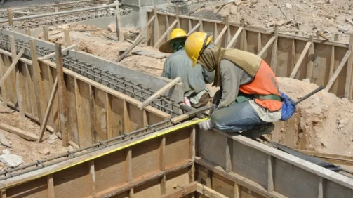 depositphotos_73965839-stock-photo-two-construction-workers-installing-ground